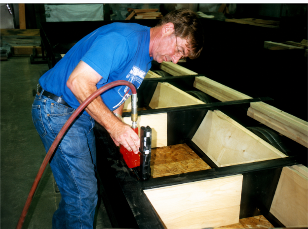 Operator using an Air Safe pneumatic fastening tool to attach modular construction components
